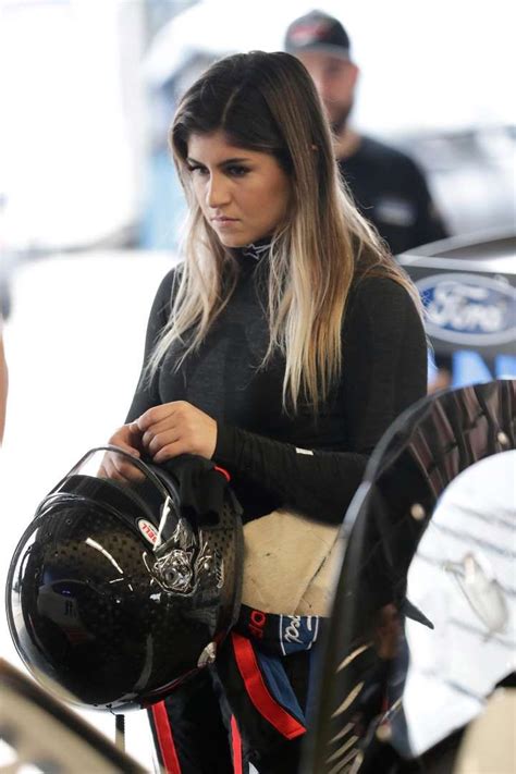 Hailie Deegan Adjusts Her Helmet In Her Garage Before The Start Of A