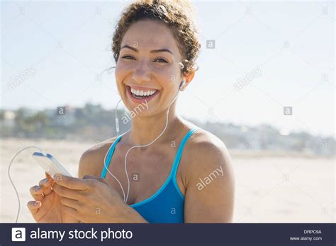 Portrait Of Active Woman Listening To Music At Beach Stock Photo Alamy