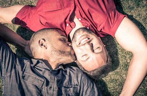 Happy Gay Couple Lying Down On The Grass Stock Photo Adobe Stock