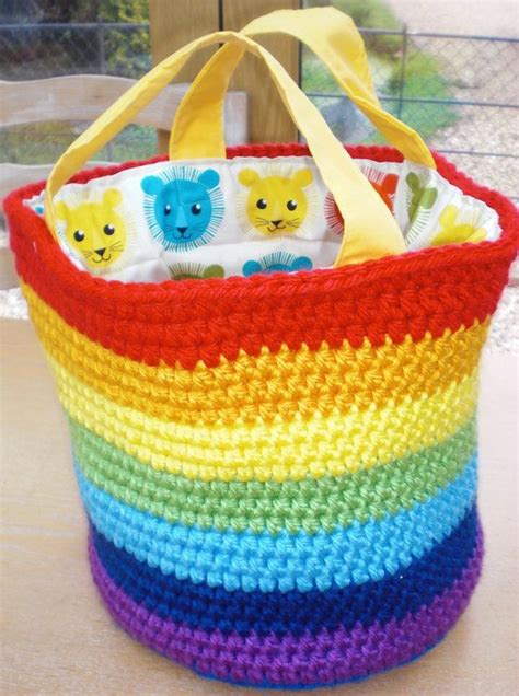 A Multicolored Crocheted Basket With Stuffed Animals On It