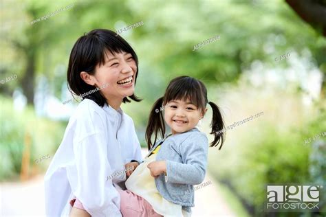 Japanese Mother And Daughter At A City Park Stock Photo Picture And