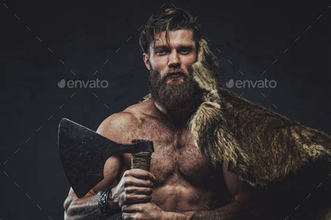 Wild And Shirtless Viking Posing In Dark Background With Axe Stock