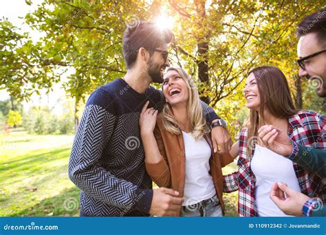 Group Of Young People Walking Through Park Stock Photo Image Of