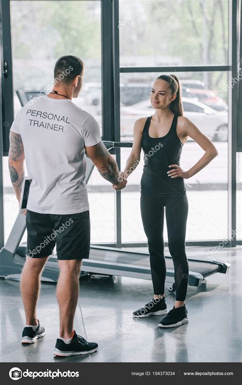 Rear View Male Personal Trainer Young Sportswoman Shaking Hands Gym