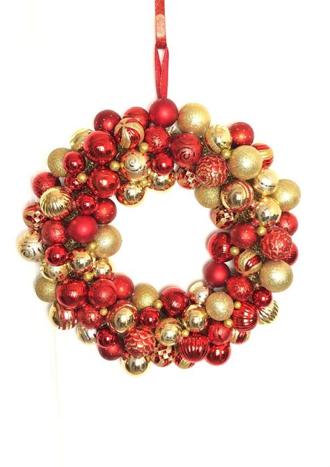 A Red And Gold Christmas Ornament Wreath