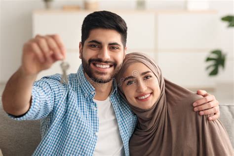 Joyful Middle Eastern Couple Showing Key Smiling Sitting At Home Stock Image Image Of Arab