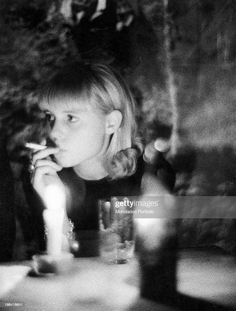 A Girl Smoking A Cigarette During A Cocktail Party In A Club Of