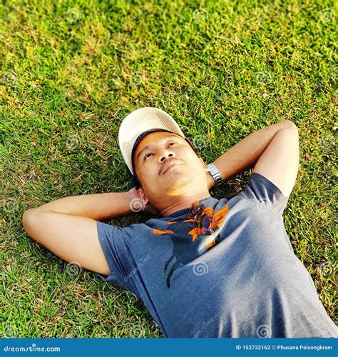 Man Lying Down On Grass Stock Photo Image Of Handsbehindhead