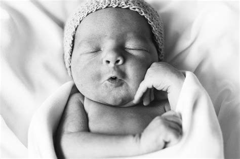 A Black And White Photo Of A Sleeping Baby