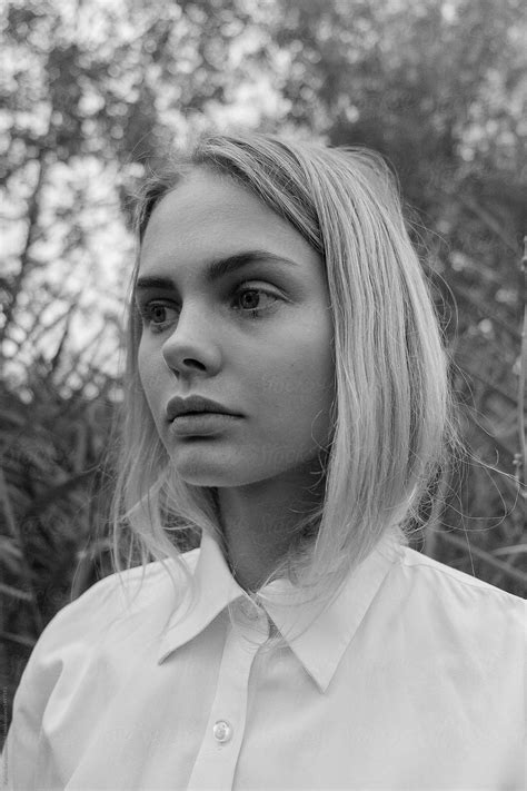 Black And White Portrait Of A Beautiful Sad Blonde Girl In White Shirt