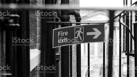 A Green Fire Exit Sign On The Wall Stock Photo Download Image Now
