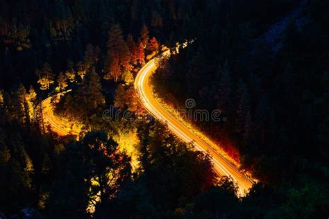 Steep Mountain Road Curves With Vehicles Blurring Of Headlights Stock