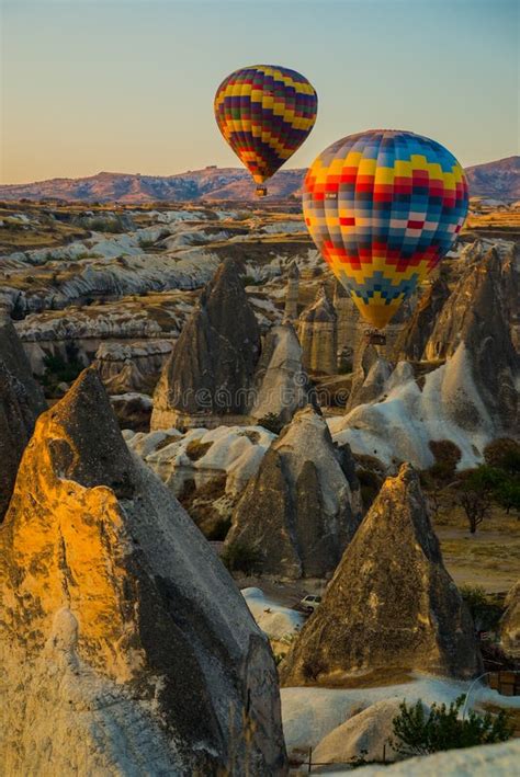 Hot Air Balloons At Sunrise Flying Over Cappadocia Turkey A Balloon
