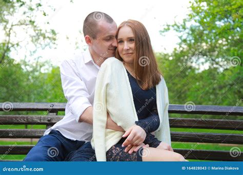 Romantic Couple On A Bench Hugs And Enjoys Together In Love Stock Image