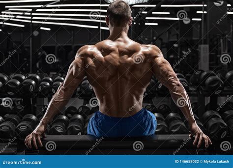 Rear View Muscular Man Showing Back Muscles At The Gym Strong Male