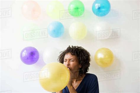 Black Woman Inflating Balloon Stock Photo Dissolve