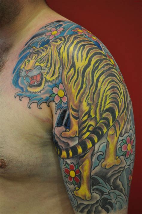 Yellow Ink Tiger Tattoo On Shoulder And Half Sleeve