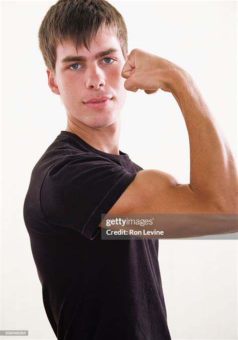 Teen Boy Flexing His Bicep Portrait High Res Stock Photo Getty Images