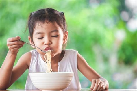 Premium Photo Cute Asian Child Girl Eating Delicious Instant Noodles