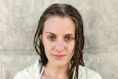 Portrait Of A Young Woman With Wet Hair Covered With A Towel Outdoors