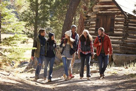 Six Friends Walking On Forest Path Near A Log Cabin Stock Image Image