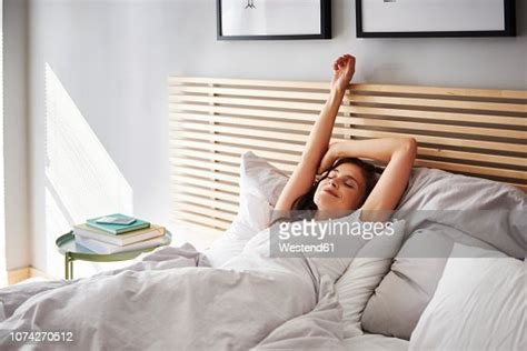 Smiling Young Woman Relaxing In Bed Photo Getty Images