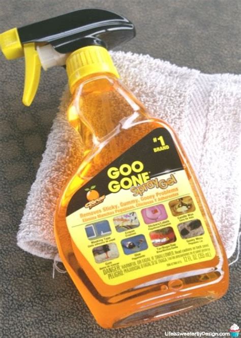 A Bottle Of Cleaner Sitting On Top Of A Towel Next To A Yellow Sprayer