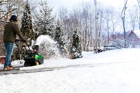 Snowblower In Action During A Snowstorm In The Blizzard Stock Photo