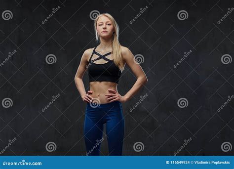 Slim Blonde Girl In A Sportswear Posing In A Studio Stock Photo