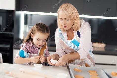 Premium Photo Grandmother Teaches Her Granddaughter How To Cook