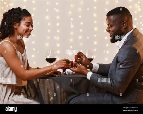Young Black Couple Getting Engaged In Restaurant Stock Photo Alamy