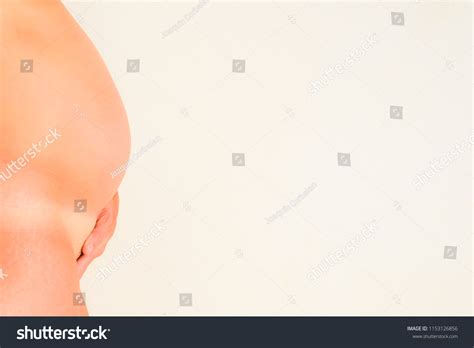 Naked Pregnant Woman Showing Her Belly Stock Photo