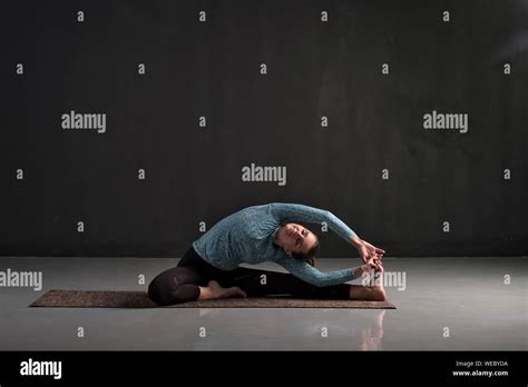 Caucasian Woman Sitting In Yoga Pose Parivrtta Janu Sirsasana Studio