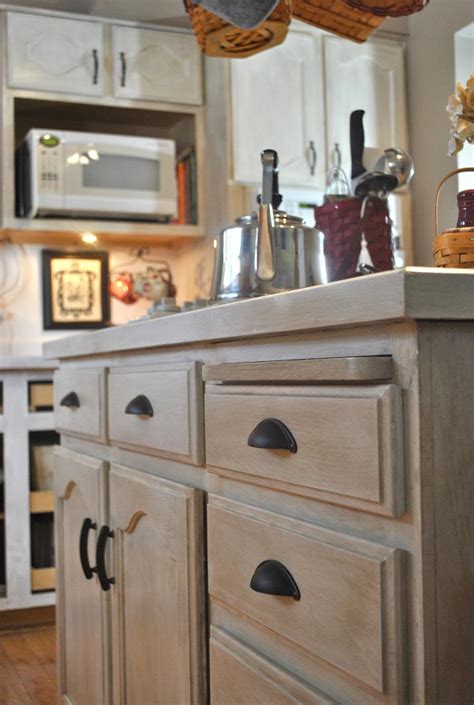 The crisp, white upper walls lend an open and airy vibe. Photos of whitewashed kitchen cabinets