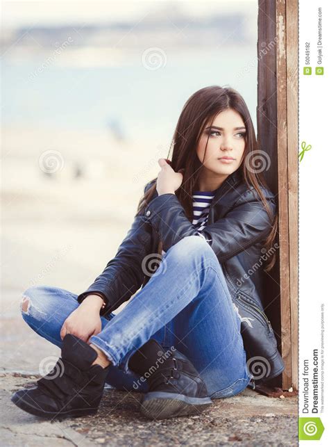 15 you have green eyes and curly/round blond hair. Portrait Of A Young Woman Sitting On The Sidewalk. Stock ...