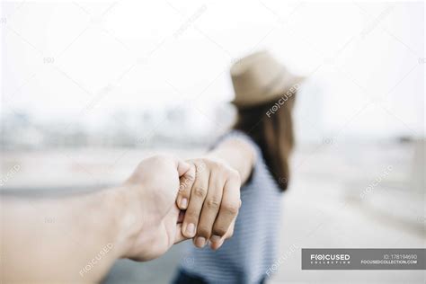 Couple holding hands view from personal perspective — stylish, hat ...