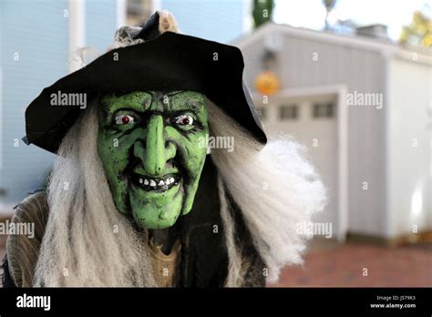 A Green Witches Face Mask On Display To Celebrate Halloween Outside A
