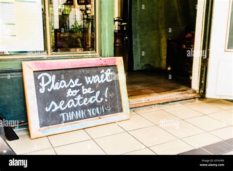 Sign Outside A Restaurant Saying Please Wait To Be Seated Thank You