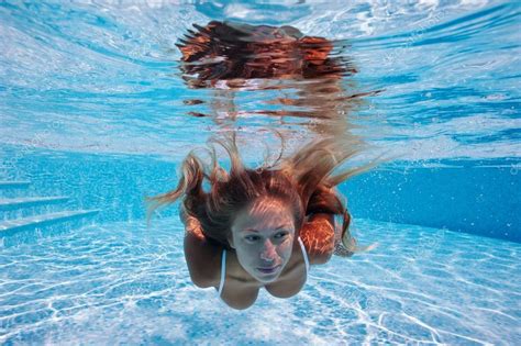 Close Up Portrait Of Underwater Woman In Swimming Pool Stock Photo