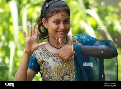 indian teenage girl showing and pointing with finger number six while smiling confident and