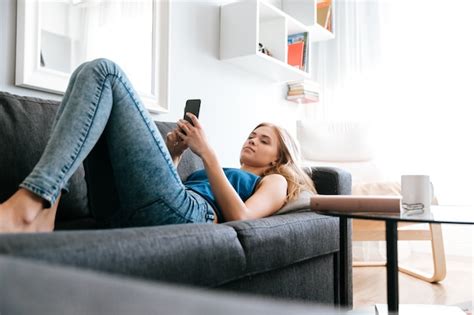 Free Photo Woman Lying On Sofa And Using Cell Phone At Home