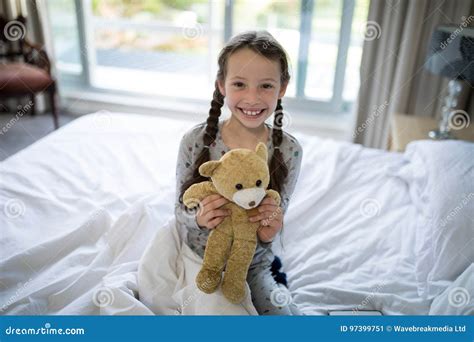 Girl Holding Teddy Bear On Bed In Bedroom Stock Image Image Of Happy