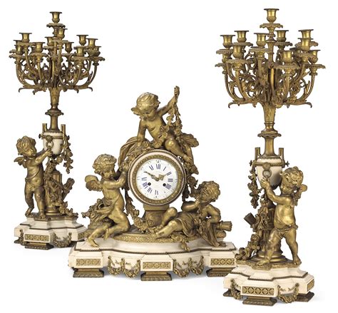 A French Ormolu And White Marble Three Piece Clock Garniture By