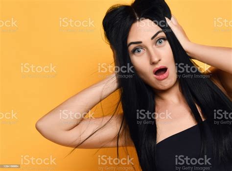 Portrait Of Upset Shocked Brunette Woman Holding Hands At Grabbing Her Head Groaning Sighing