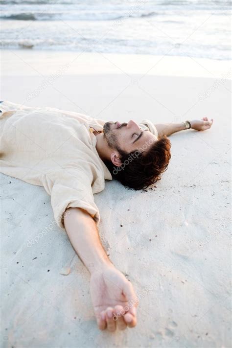 Man Lying Down On Beach Stock Photo By ©mjth 45812093