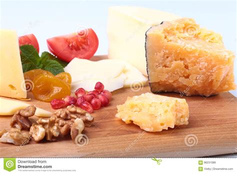 Assortment Of Cheese With Fruits Grapes Nuts And Cheese Knife On A