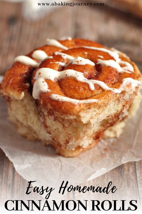 Cinnamon Rolls With Icing Sitting On Top Of Wax Paper