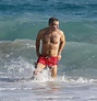 Andy Cohen hits the beach in fire red trunks with hunky boyfriend ...