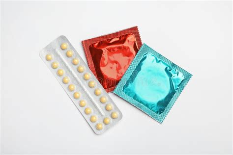 condoms and birth control pills on blue background flat lay safe sex concept stock image