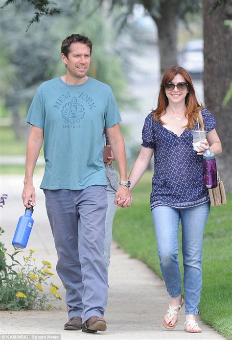 alyson hannigan and husband alexis denisof enjoy a coffee together during a well earned break